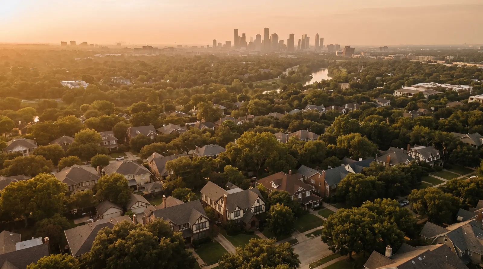 Aerial view of tree-lined Austin streets with towers in the distance